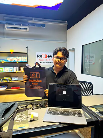 Pelanggan dengan MacBook dan beg ReDevice di kaunter